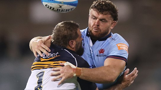 Tom Lambert of the Waratahs is tackled by James Slipper of the Brumbies