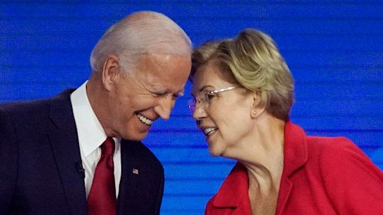 Democratic presidential contenders Joe Biden and Elizabeth Warren speak on stage in Houston at the Democratic debate
