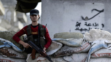 A Syrian opposition fighter stands at a checkpoint in the north-western city of Idlib, Syria, in October.