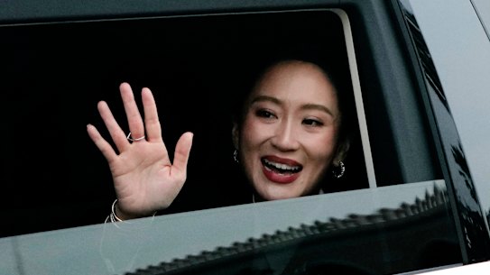 Thailand’s ousted Prime Minister Paetongtarn Shinawatra waves as she leaves Government House in Bangkok after being dismissed from her position on Friday.