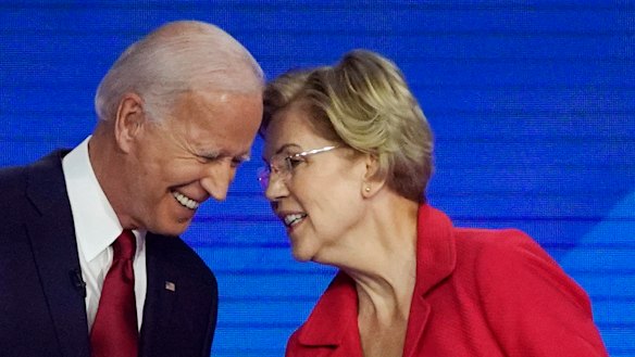 Democratic presidential contenders Joe Biden and Elizabeth Warren speak on stage in Houston at the Democratic debate.