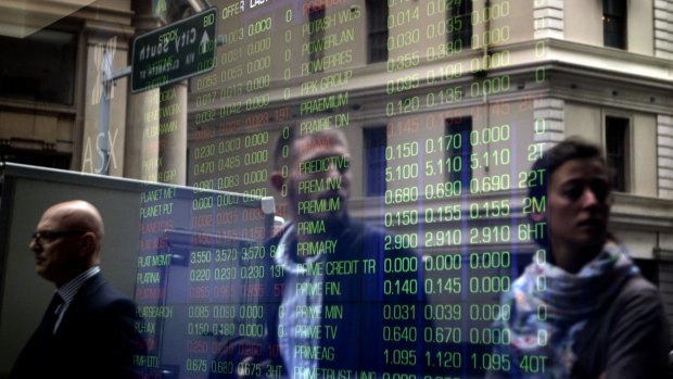 A reflection of passersby and the ASX stock board on Bridge Street in Sydney. generic stock exchange ASX  investor shares portfolio