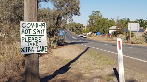 A handmade sign warns road users that Broken Hill has become a "hotspot" for the coronavirus.