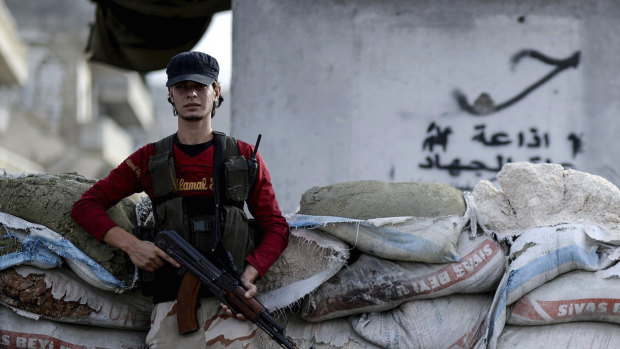 A Syrian opposition fighter stands at a checkpoint in the north-western city of Idlib, Syria, in October.