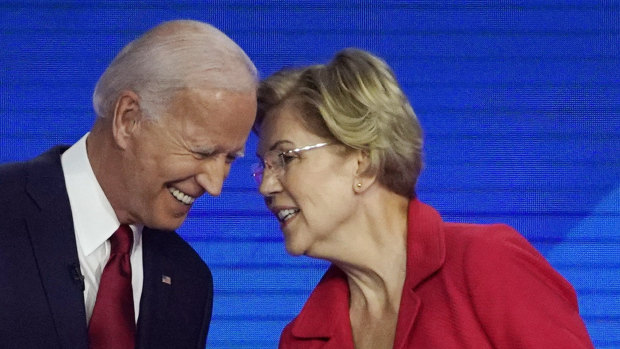 Democratic presidential contenders Joe Biden and Elizabeth Warren speak on stage in Houston at the Democratic debate.