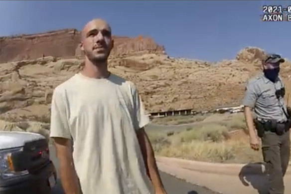 A police camera video still shows Brian Laundrie talking to a police officer on August 12.