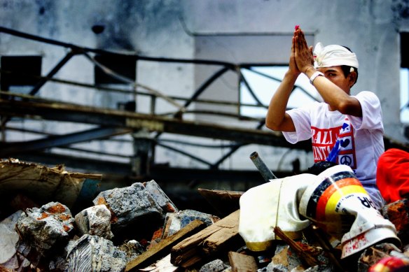 A Balinese man prays over the rubble of the Sari Club in November 2002. The idea of the Ubud Writers and Readers Festival was a repudiation of that year's terrorist attacks on the island.