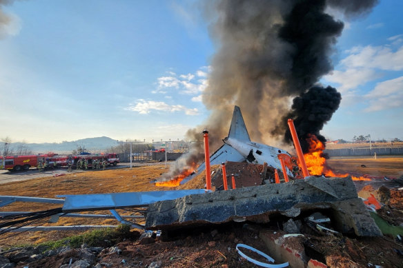 The crashed plane burns at Muan International Airport in Muan, South Korea.
