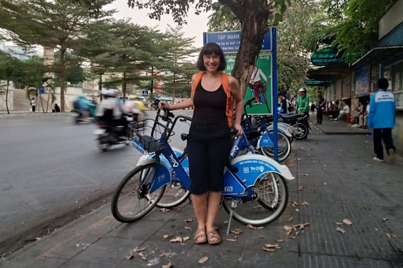 Dr Dorina Pojani, from The University of Queensland’s School of Architecture, Design and Planning, in Hanoi, in front of a hire bike from TNGo.