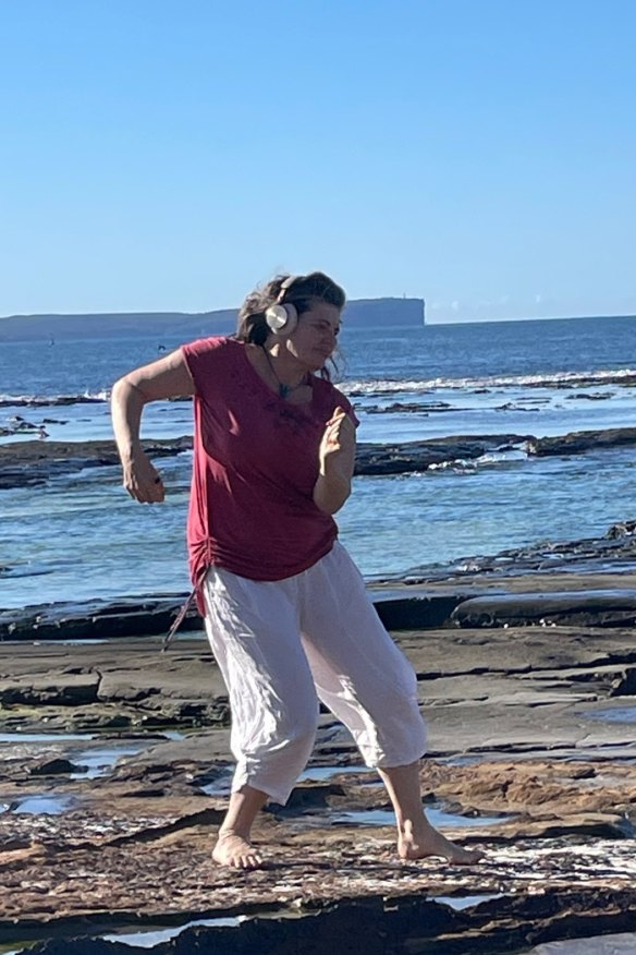 Chick dancing bare-footed on the rocks at Jervis Bay.