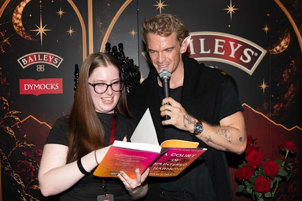 Cody Simpson roped a fan into reading with him at the midnight launch event for A Court of Splintered Harmony at Dymocks Sydney.