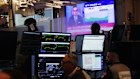 A television broadcasts oil price news on the floor at the New York Stock Exchange. Brent crude has soared, slumped and soared again.