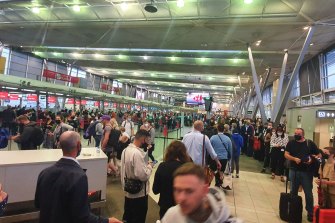 Passengers face long queues at Sydney Airport.