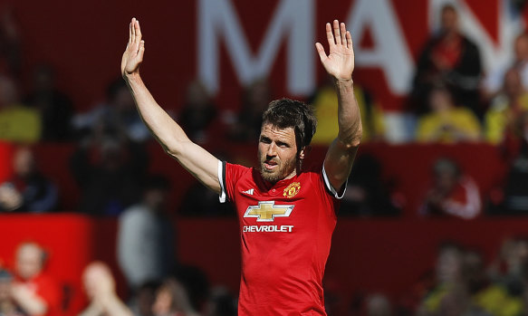 Manchester United's Michael Carrick salutes the fans as he leaves the field after his final playing appearance.