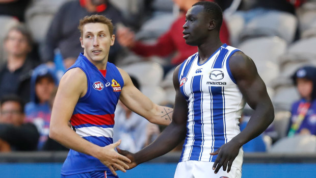 Happy returns: Bulldogs' Bailey Dale greets North Melbourne defender Majak Daw before kick-off at Marvel Stadium.