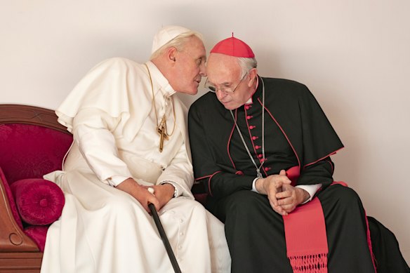 Jonathan Pryce as Cardinal Bergoglio, right, and Anthony Hopkins as Pope Benedict in a scene from The Two Popes. 
