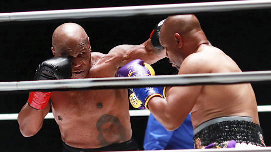 Mike Tyson throws a punch against Roy Jones jnr.