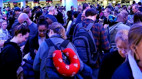 Travellers returning from Madrid wait in a coronavirus screening line at Chicago's O'Hare International Airport.