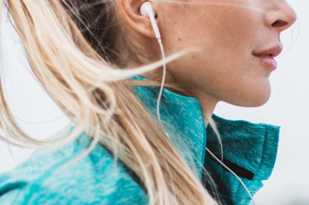 Stock image of a woman wearing wired headphones