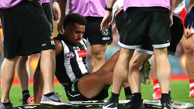 Isaac Quaynor gets helped after suffering a serious cut to his leg.