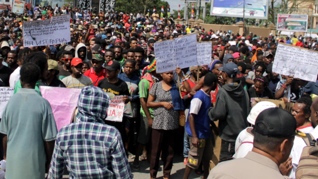 Papuans hold posters during a protest in Timika, Papua province.