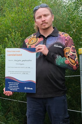 Foreshore Team Leader Jamie Davies erecting another vandalism sign on Bicton foreshore to call attention to the repeated destruction of trees.