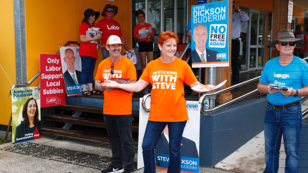 One Nation leader Senator Pauline Hanson hands out how to vote cards at the polling booth set up at Mountain Creek State School in Buderim, during the 2017 state election.