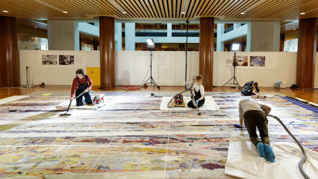 Conservation and heritage students at the University of Canberra got hands-on experience vacuuming the sprawling tapestry.