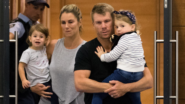 David Warner arrives with his family in Sydney on Thursday night.