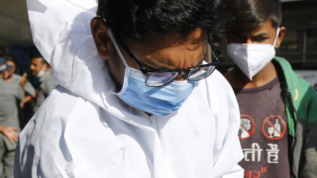 A health worker takes a nasal swab to test for COVID-19 at state transport bus stand in Ahmedabad. Prime Minister Narendra Modi’s government has indicated it may need 300 million doses of the vaccine before July 2021.