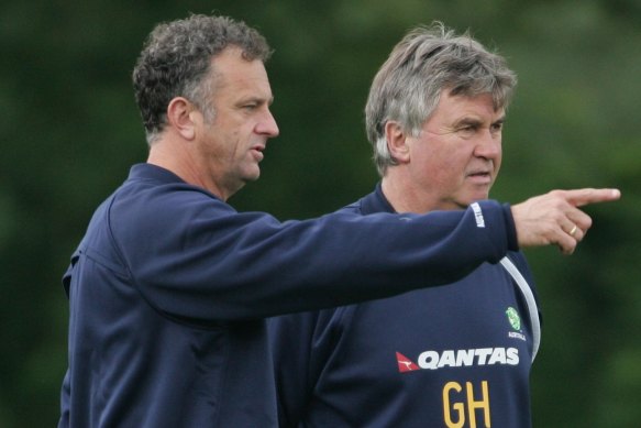 Former Socceroos coach Guus Hiddink, right, with then-assistant Graham Arnold in 2006. Arnold is now in his second stint as Socceroos coach.