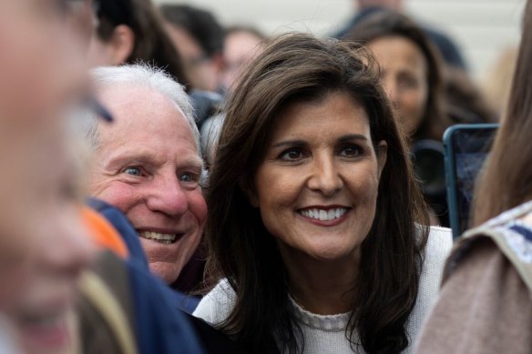 Nikki Haley takes photos during a bus tour campaign event in Moncks Corner, South Carolina.