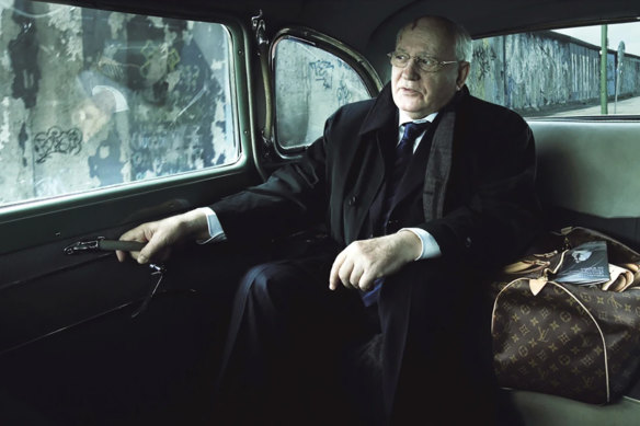 Former USSR leader Mikhail Gorbachev passes by the Berlin Wall in the advertisement shot by Annie Leibovitz. 