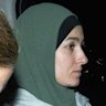 Janai Safar is escorted from Sydney Airport to Mascot police station after returning to Australia from Syria on Thursday night.