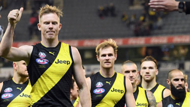 Under a cloud: Jack Riewoldt leads the Tigers off the field after their Anzac Day Eve win over Melbourne.