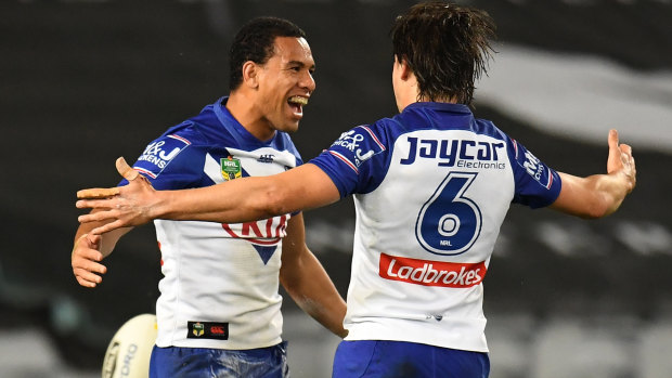 Boilover: Will Hopoate celebrates his try with Lachlan Lewis on Thursday night.
