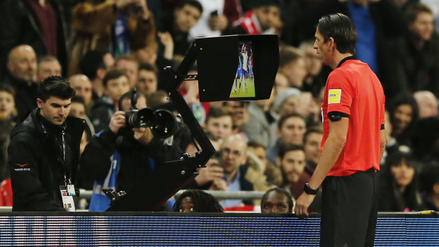 Coming to the big screen: referee Deniz Aytekin checks the VAR during a friendly between England and Italy.