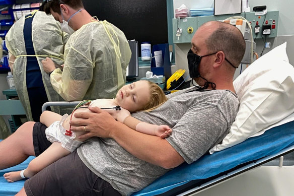 Ben Souvatzis cradles his unwell son.