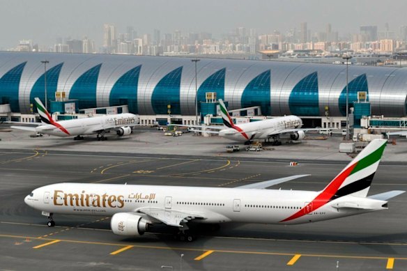 An Emirates plane taxis to a gate at Dubai International Airport in Dubai, United Arab Emirates.