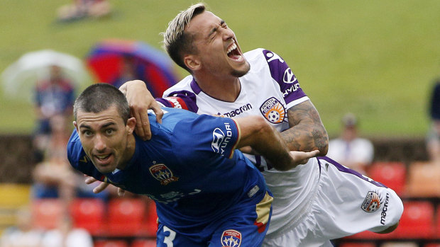 Theatre: Jason Davidson of the Glory overreacts in a tackle with Jason Hoffman.