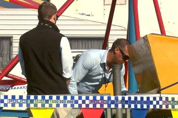 Police inspect the scene where Eugene Mahauariki, 6, died after falling from the Cha Cha ride at the 2017 Rye Easter Carnival.