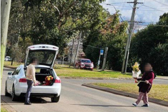 A photograph posted on Facebook appears to show people taking flowers from a roadside memorial to Rhyce Harding in Blackett, near Mount Druitt.