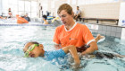 Aaron Wartmann, a swimming instructor at Auburn Ruth Everuss Aquatic Centre, with six year old Jayden Yang.  