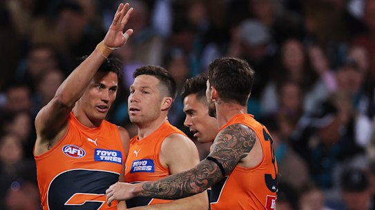 Toby Greene celebrates a goal with Giants teammates during the win over Port Adelaide.
