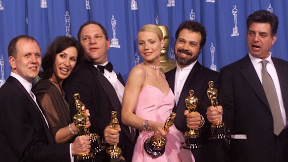 From left to right, David Parfitt, Donna Gigliotti, Harvey Weinstein, Gwyneth Paltrow, Edward Zwick and Marc Norman all celebrate after receiving the Oscar for best picture for Shakespeare In Love at the Academy Awards in 1999.