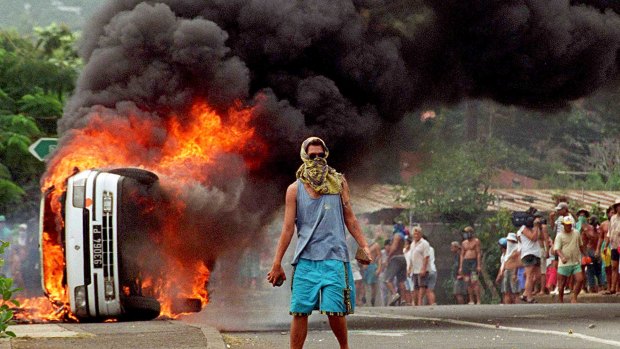 Andrew Meares' prize winning  photo of the riots in Papeete, Tahiti, on 6 September 1995 after the nuclear test explosions on Mururoa. A demonstrator faces up to French police. 