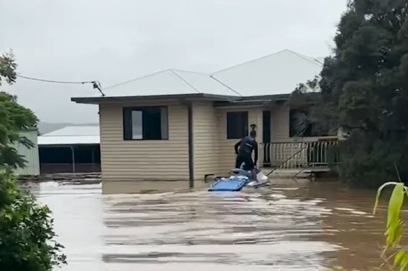 Joel Parkinson and Api Robin ob 
a jet ski checking out a house at Tumbulgum, near Murwillumbah