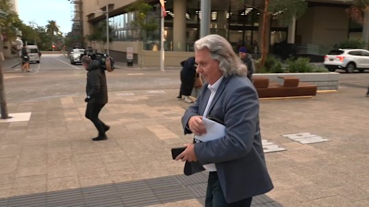 Chris Marco makes his way to court through waiting media during the first week of his trial.