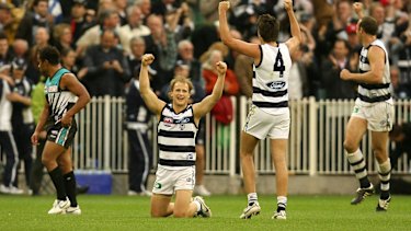 Gary Ablett, Andrew Mackie and Brad Ottens celebrate the Catsâ 2007 grand final win.