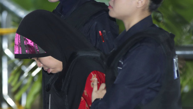 Indonesian Siti Aisyah, left, is escorted by police as she arrives for a court hearing on Thursday.